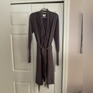 Belted long charcoal gray sweater with fringe.